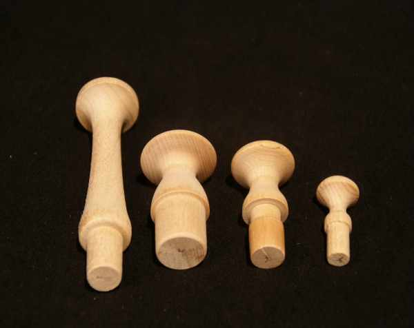 Custom wood turnings made into a variety of wooden pegs shown in different sizes